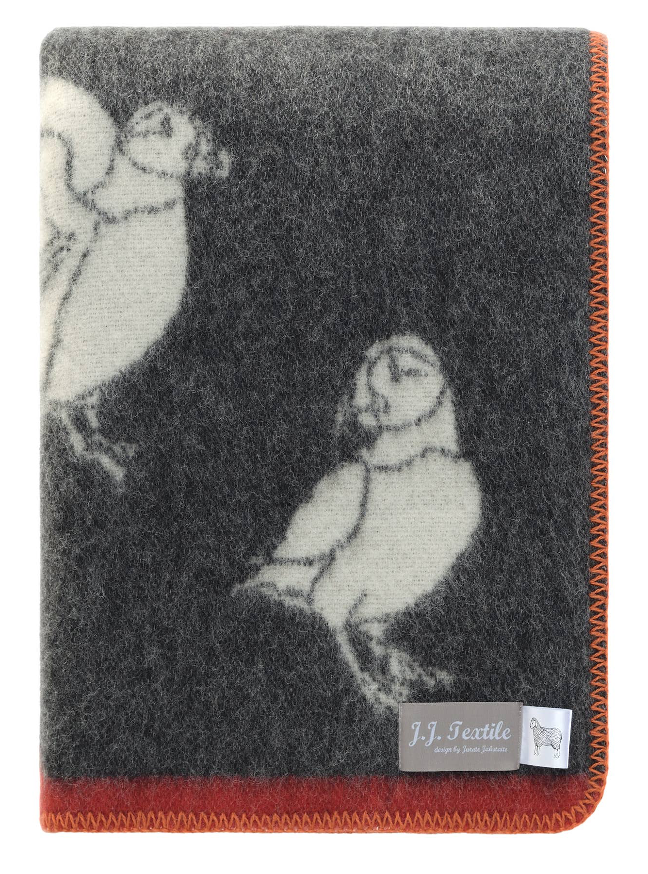 Textile with a design of two stylized puffins on a dark background, red and orange trim.